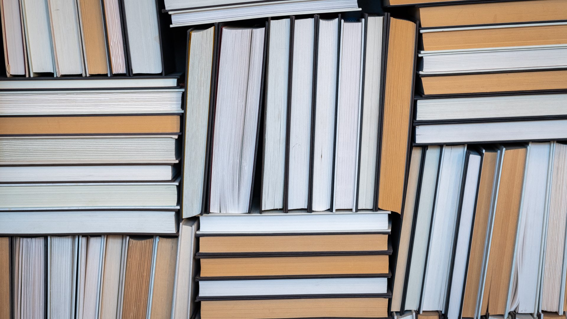 Piles of books piled vertically and horizontally 