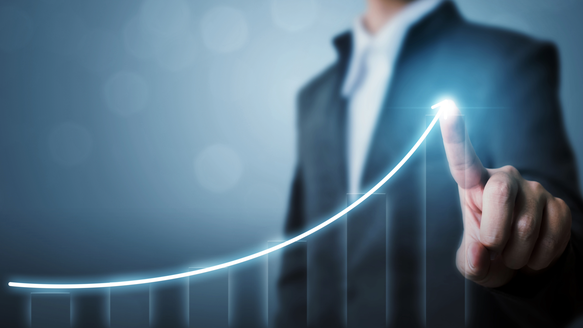 A visual graph showing a positive growth with a male using their index finger to highlight growth