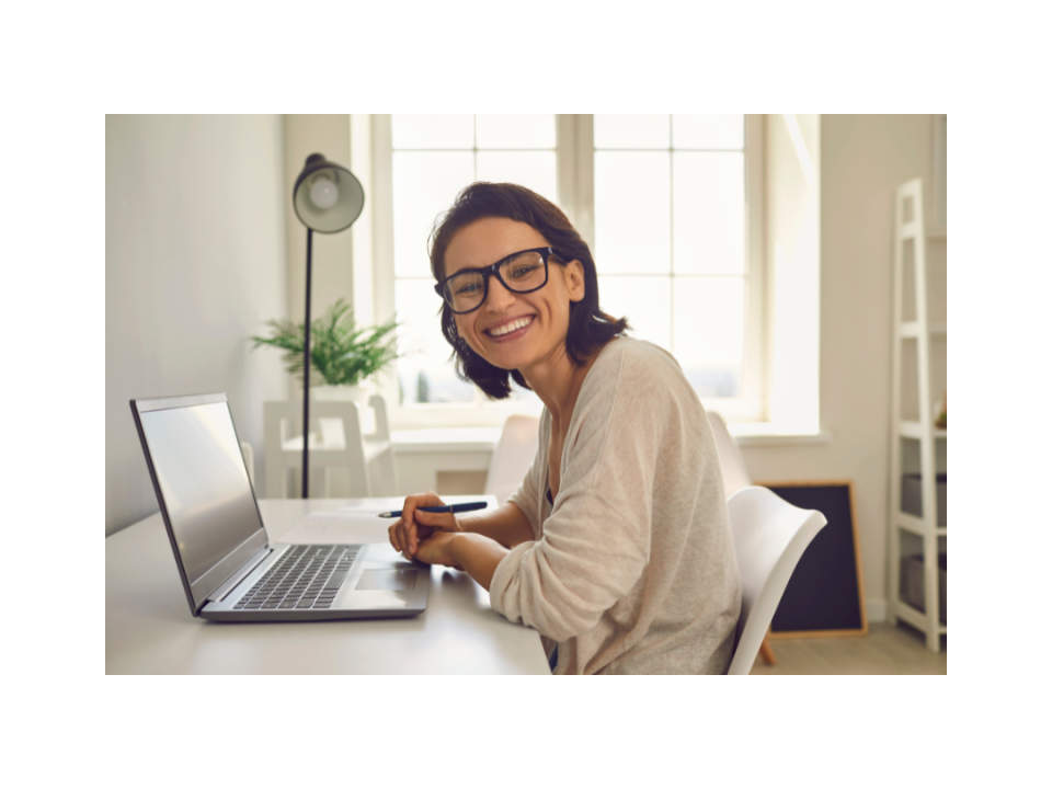 smiling woman working on computer at home