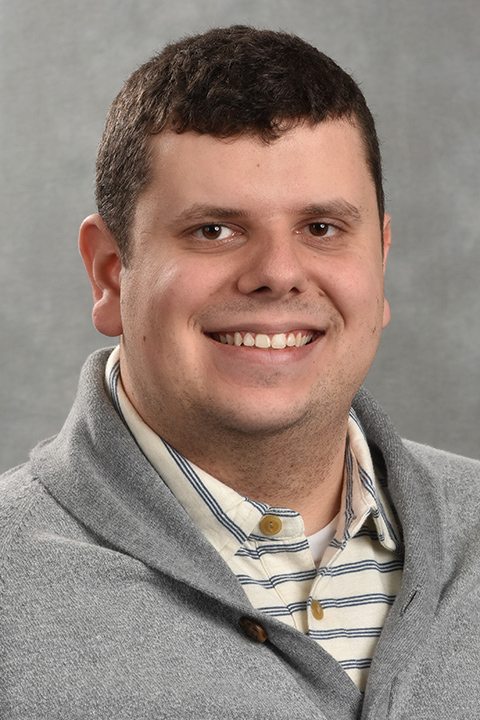 Headshot of Nicholas Krasoski against a grey background