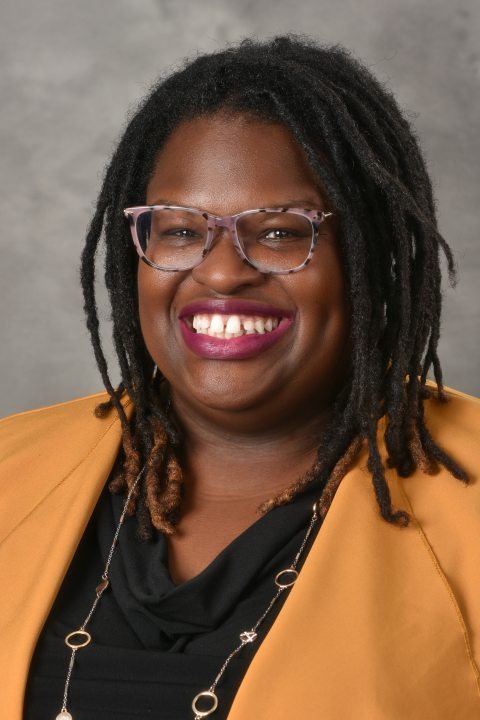 Portrait of Lillian Evans against a gray background