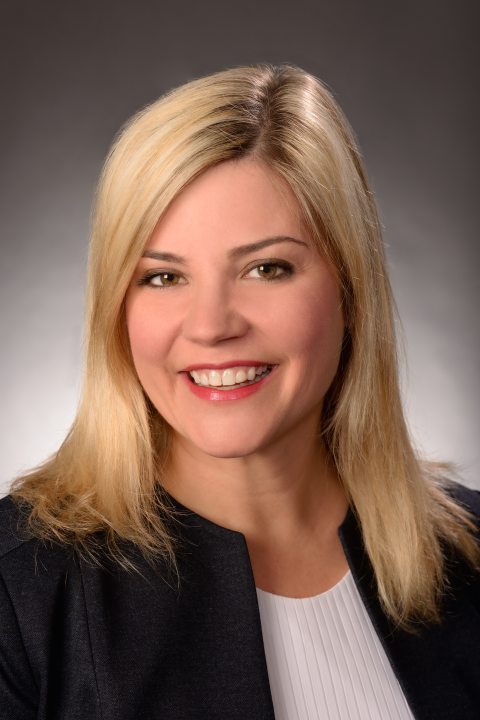 Kristen Eichhorn portrait against a gray background