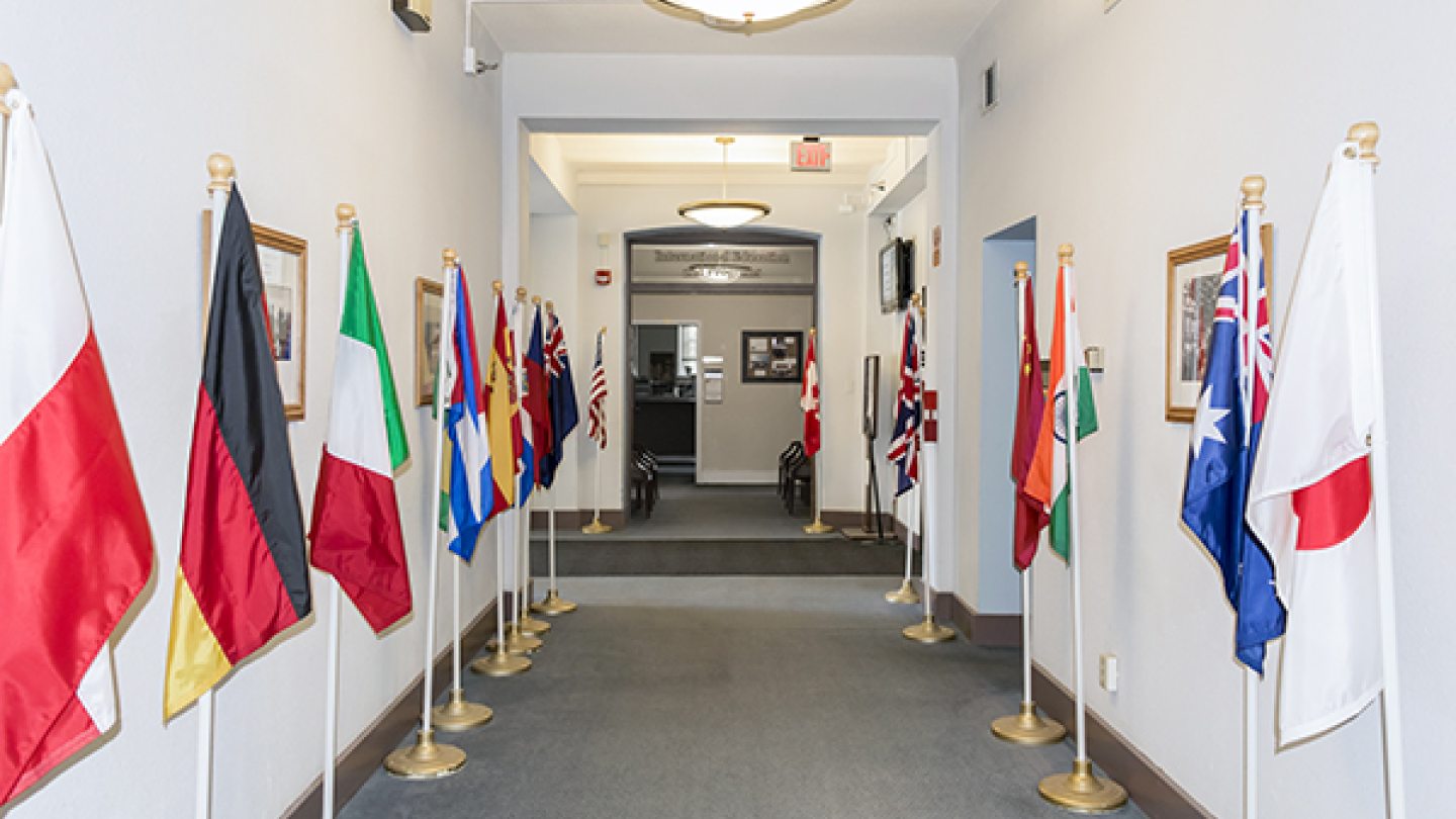 International flags lining a hallway in Sheldon Hall