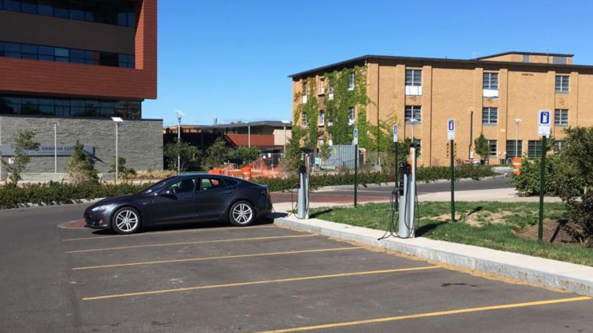 car parked in a parking lot next to the electric car chargers