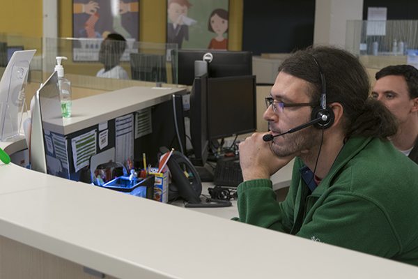 man sitting at computer with headset on