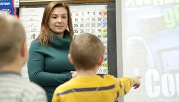 A female teacher with two young students