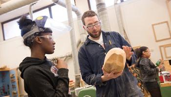 Two people with welding masks on