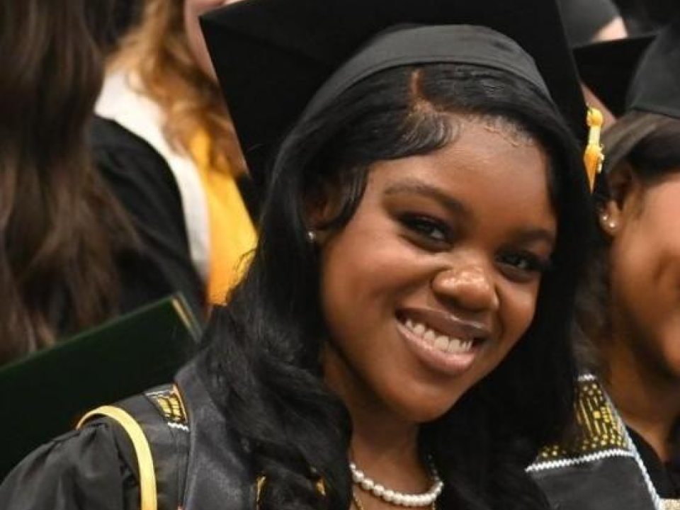 GWS awardee wearing a black cap and gown at graduation