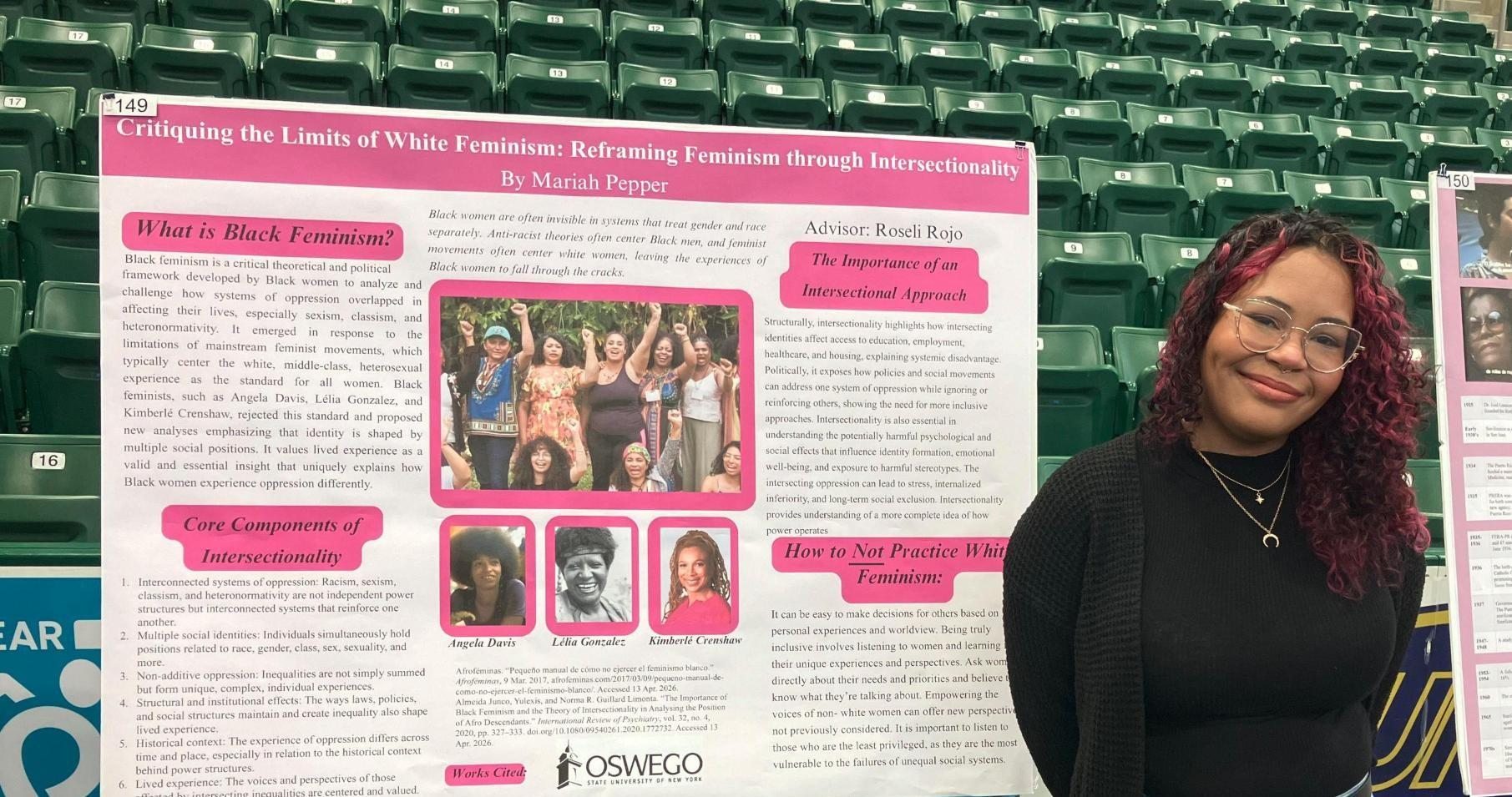 Student presenting at Quest in front of their poster titled Critiquing the Limits of White Feminism: Reframing Feminism Through Intersectionality