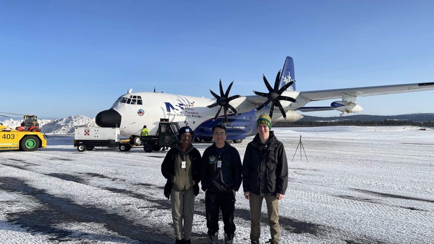 People standing in front of an airplane