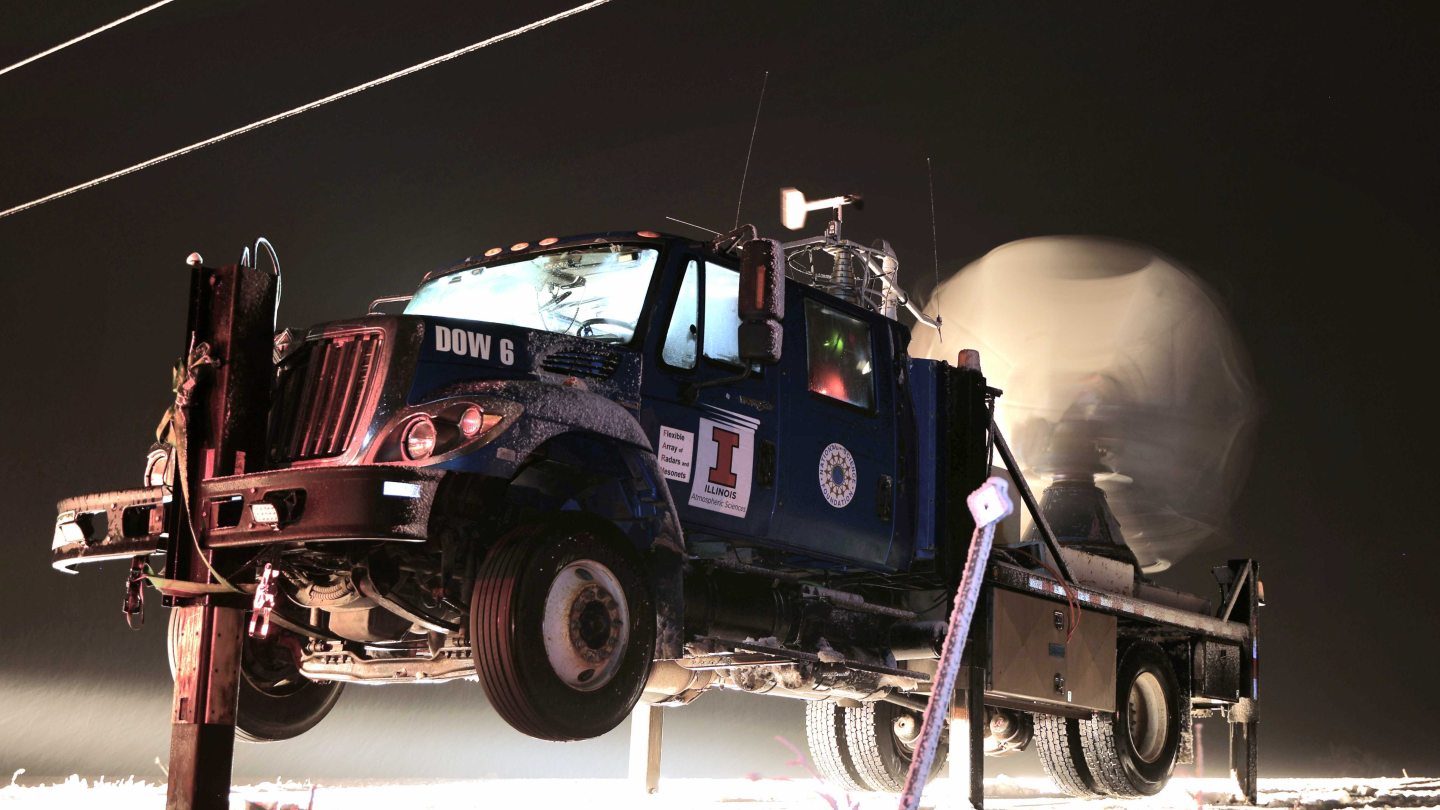 A truck, staked to the ground, with equipment to measure the weather