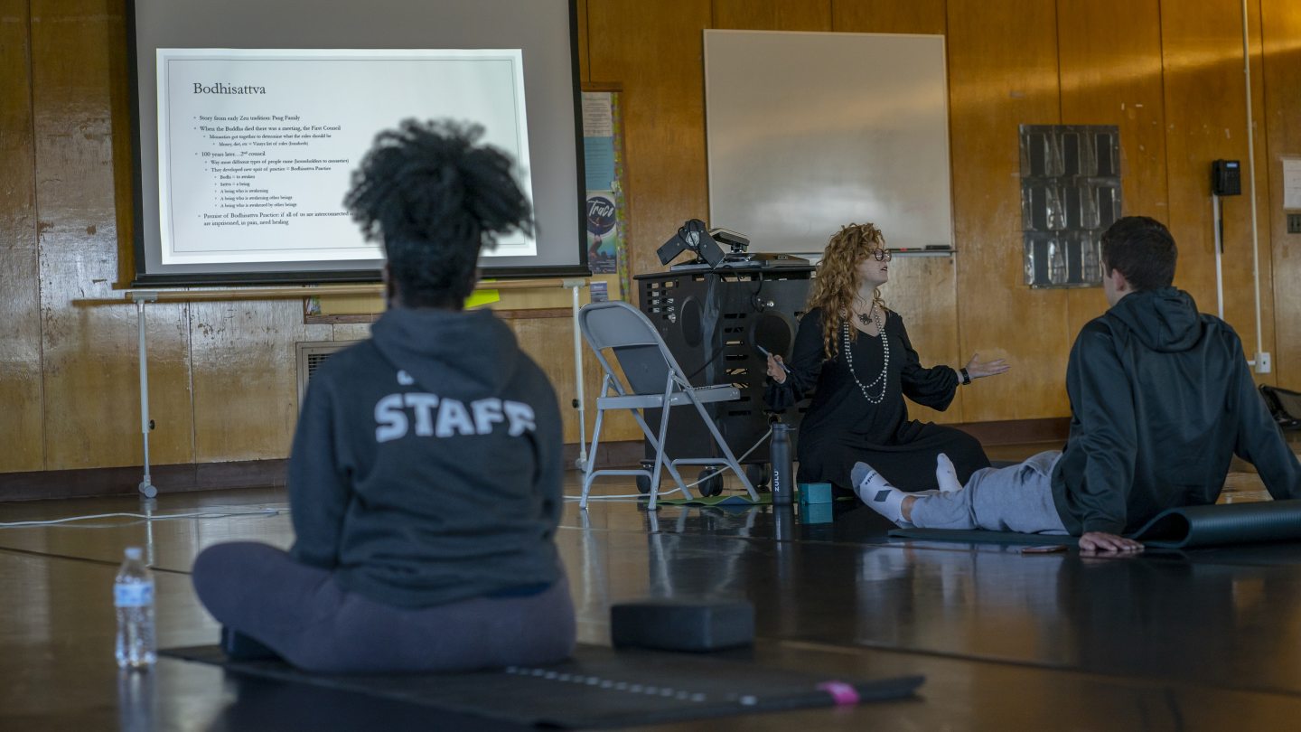 Professor Candis Haak giving a presentation on the history of yoga