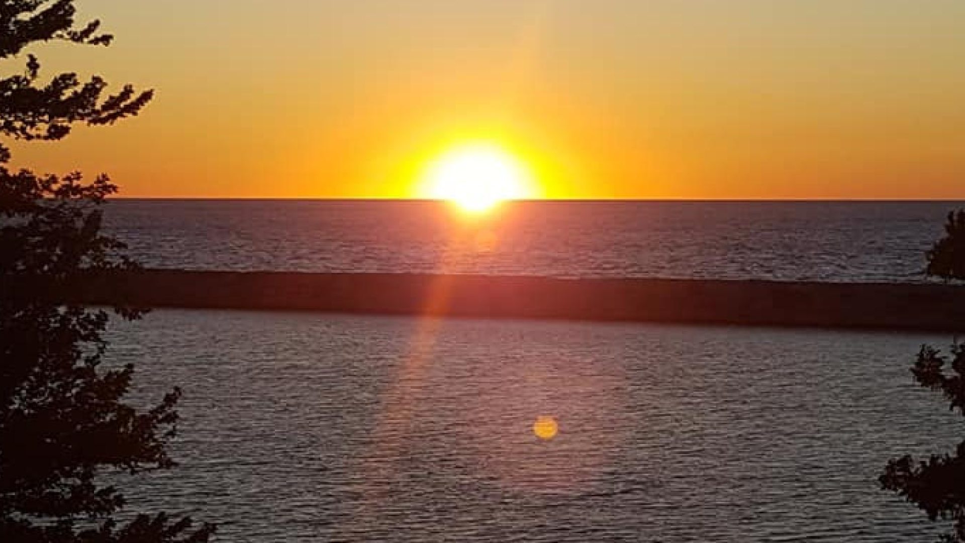 The sun setting over a body of water