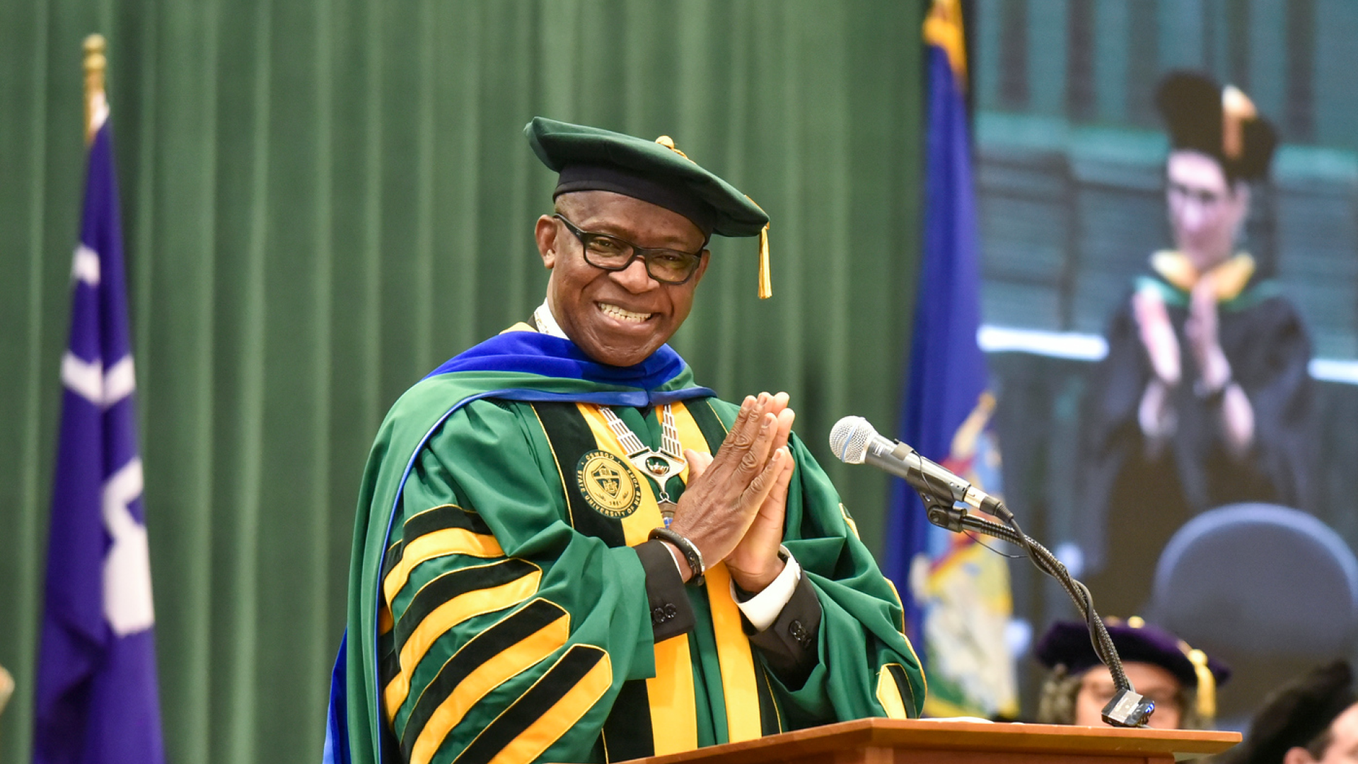 President Peter O. Nwosu at a podium, smiling
