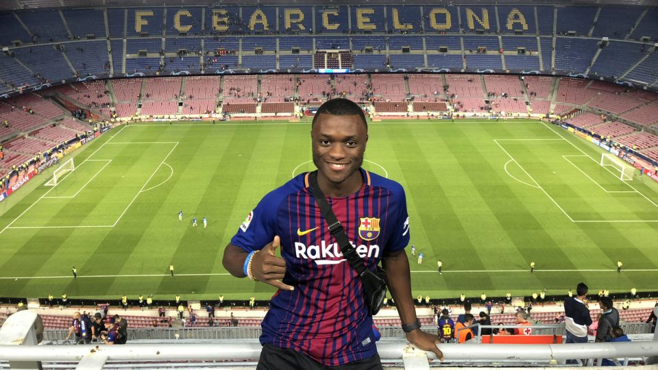 A student standing in a Barcelona football stadium
