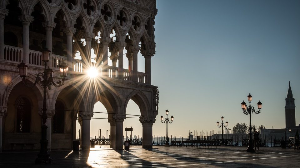 The sun shining through the pillars of a cathedral in Italy