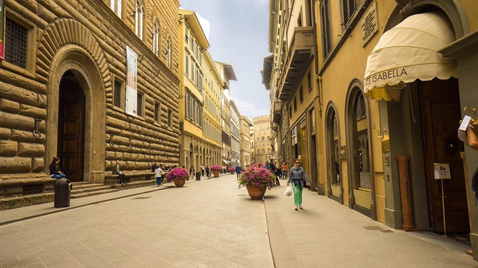 Woman walking down street in Florence, Italy