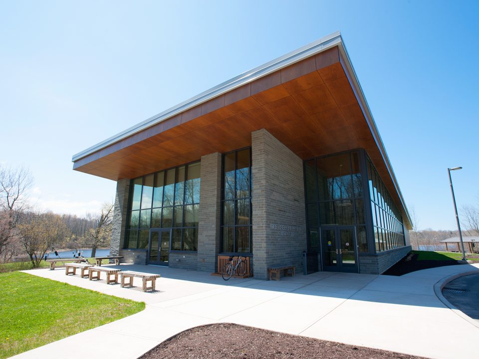 Exterior view of the Rice Creek Field Station building at SUNY Oswego, surrounded by trees and natural landscape.