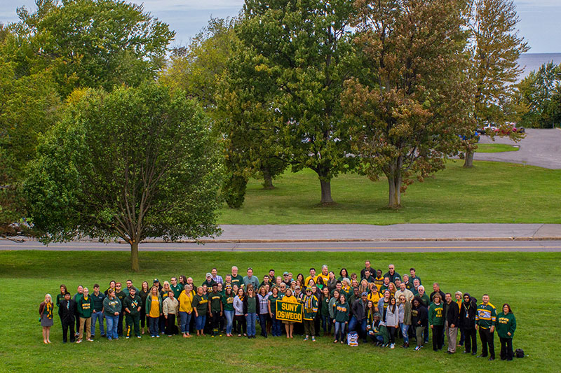 Campus community members in green and gold