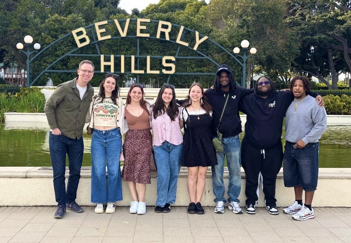 Oswego students and faculty member Michael Riecke stand in front of the Beverly Hills sign on the 2025 Hollywood POV trip. Oswego students and faculty member Michael Riecke stand in front of the Beverly Hills sign on the 2025 Hollywood POV trip.