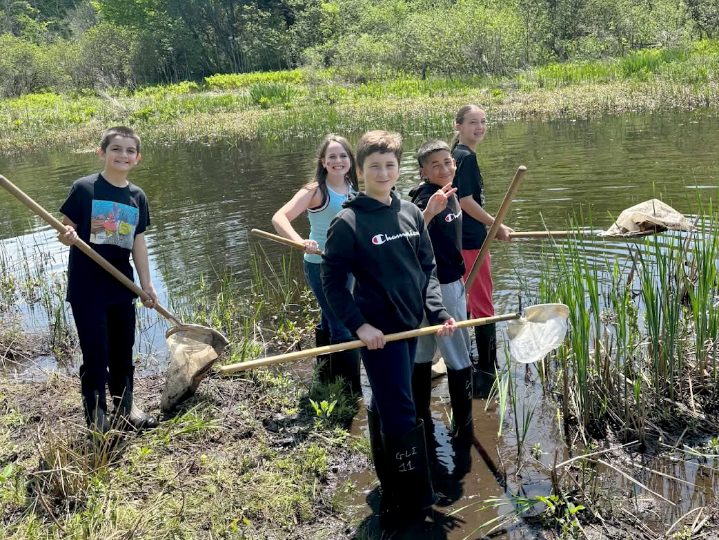 Sixth-grade students from Granby Elementary explore the Rice Creek Field Station wetlands during a recent science-themed visit.