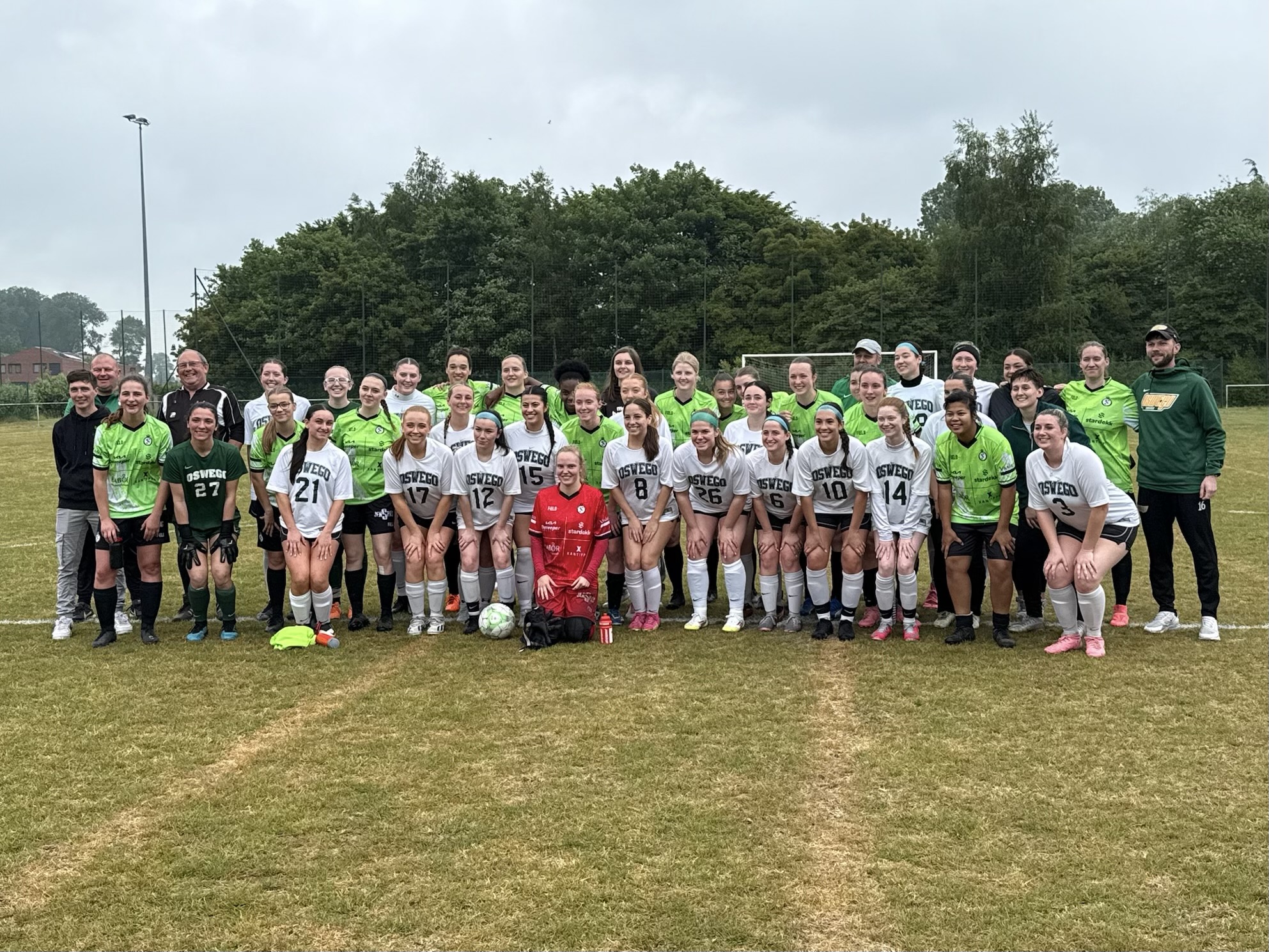 SUNY Oswego's women's soccer team and guests stand with their opponents on their trip to Europe. SUNY Oswego's women's soccer team and guests stand with their opponents on their trip to Europe.