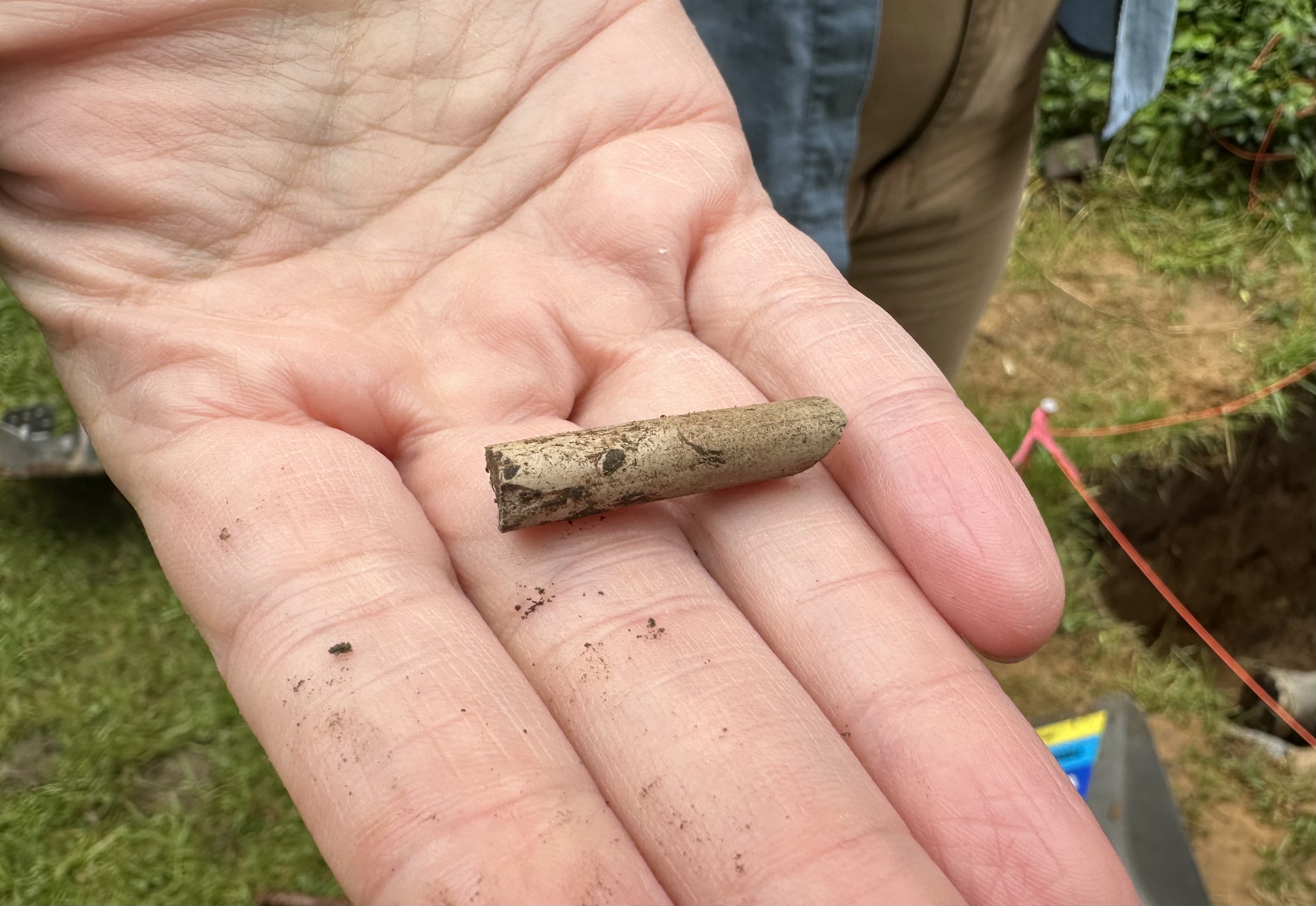 Piece of clay pipe found during 2024 archaeological dig. Piece of clay pipe found at archaeological dig site.