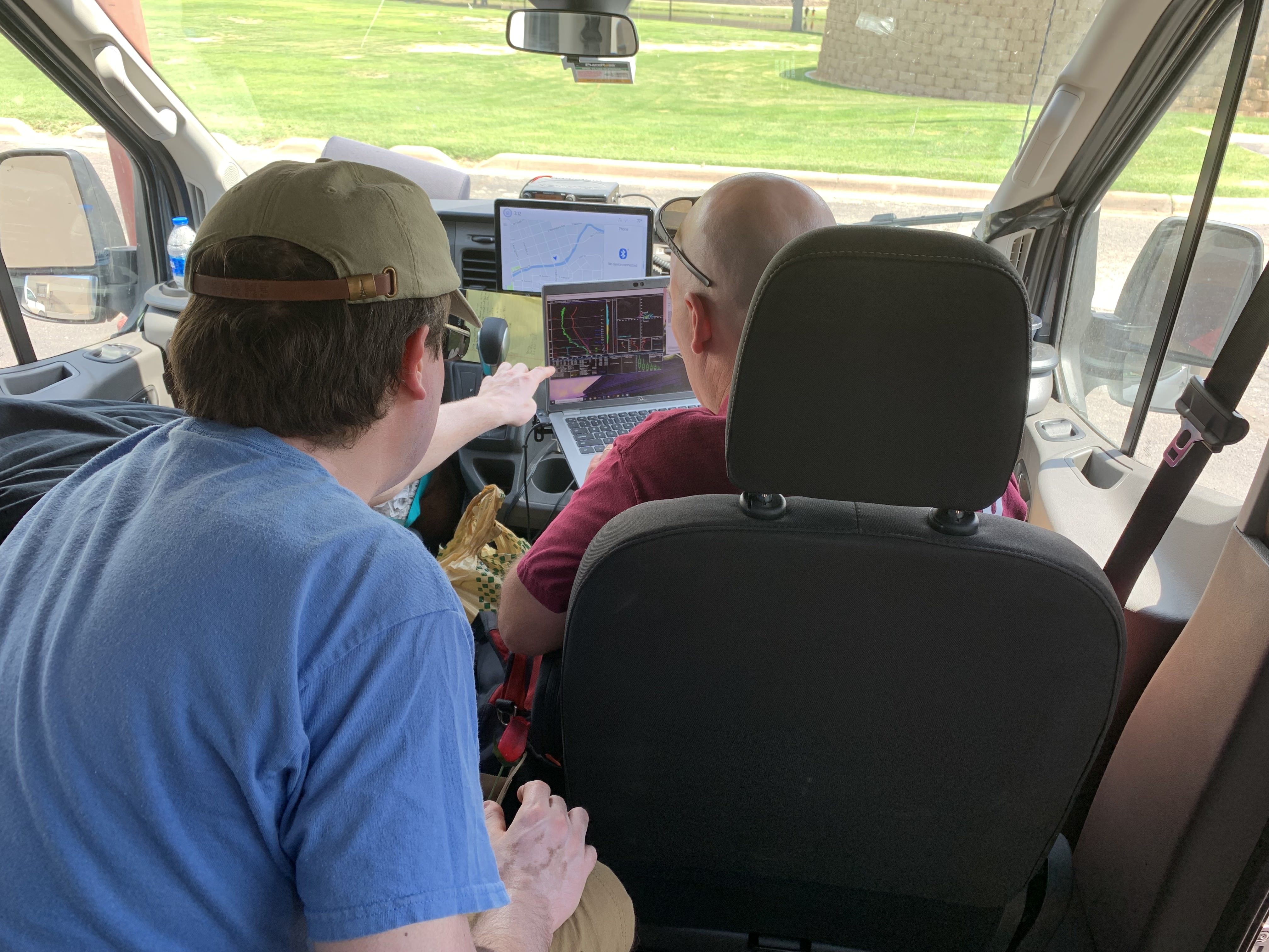 Student looking at data in the storm chasing van. Student looking at data in the storm chasing van.