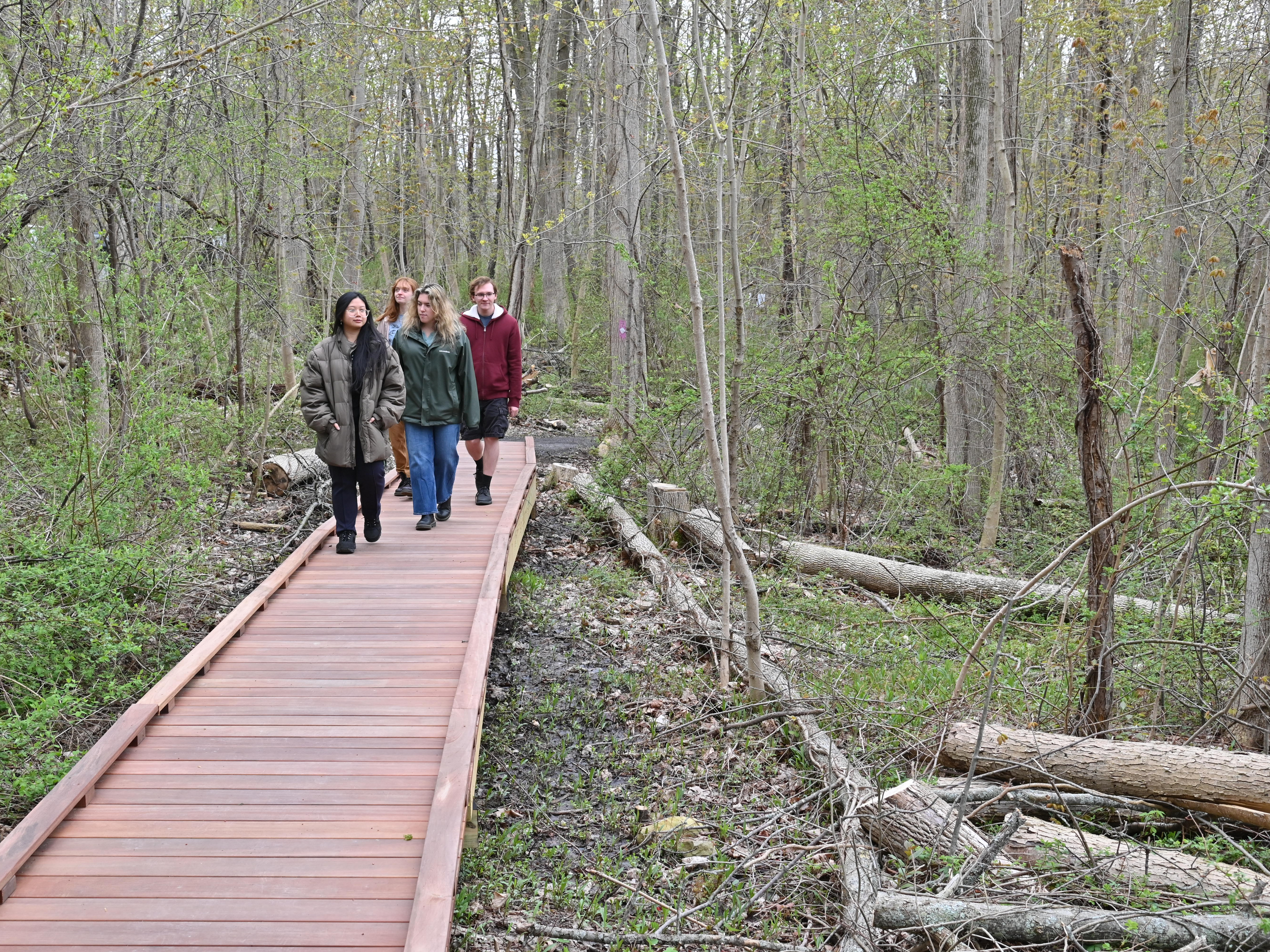 Students attending the grand opening celebration of Rice Creek Field Station's new accessible Purple Trail take a quick stroll.