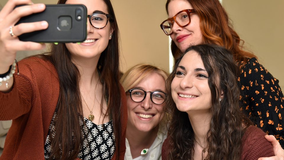 Christene Barberich, global editor-in-chief and co-founder of Refinery29, poses with art students