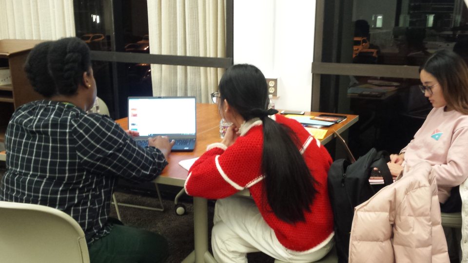 Michelle Bishop of Penfield Library works with students in this image from fall 2019
