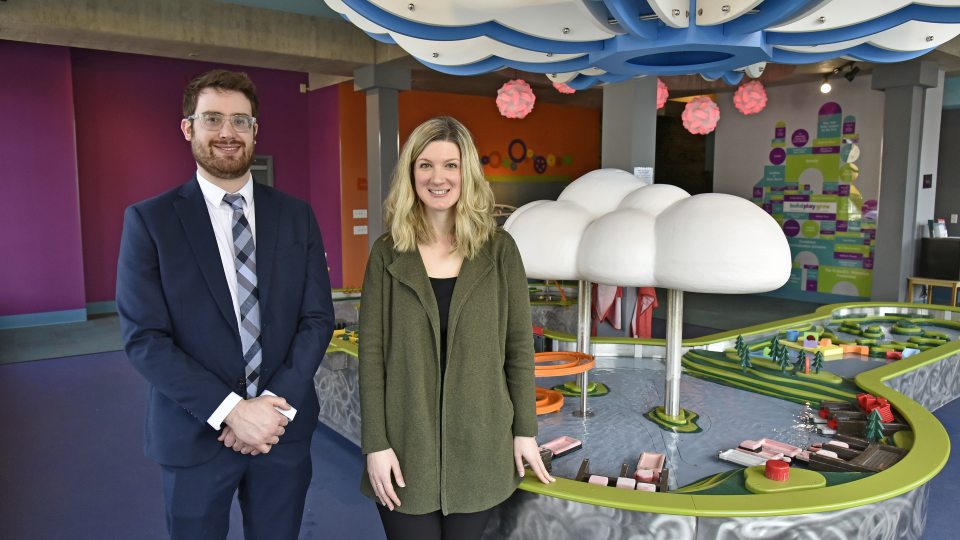 Professor Zachary Gold and Executive Director Kathryn Watson on the first floor of the Children's Museum in front of the water table