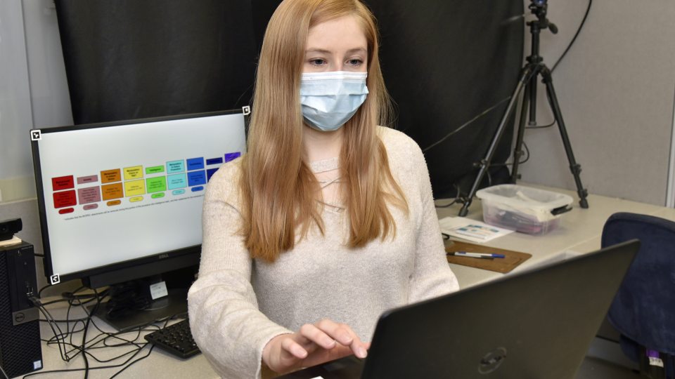 Psychology student Quinn Ceilly works in a Mahar Hall lab