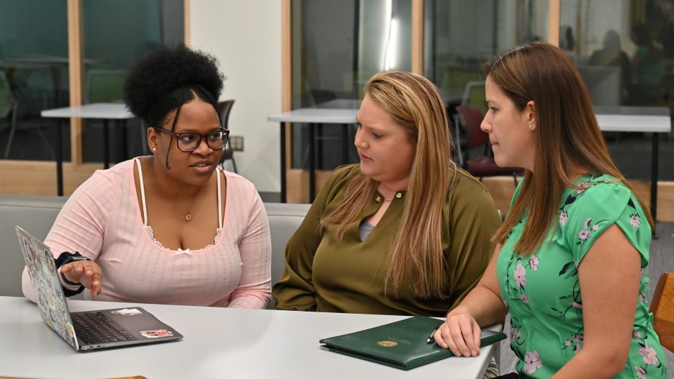 Gabriella Patterson, a double major in wellness management and psychology, works on her Quest project with health promotion and wellness faculty members and mentors Jessica Harris and Elizabeth Kieda