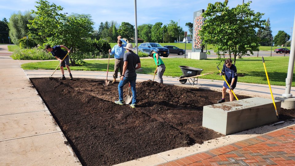 Student and staff volunteers planting the alvar garden outside Shineman Center.