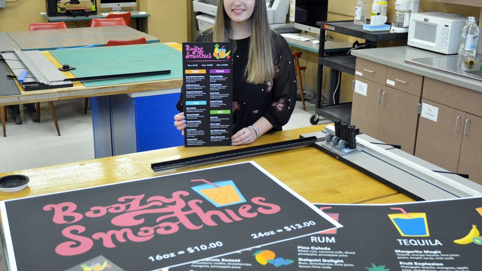 Art student Julie Farquhar poses with pieces from her portfolio