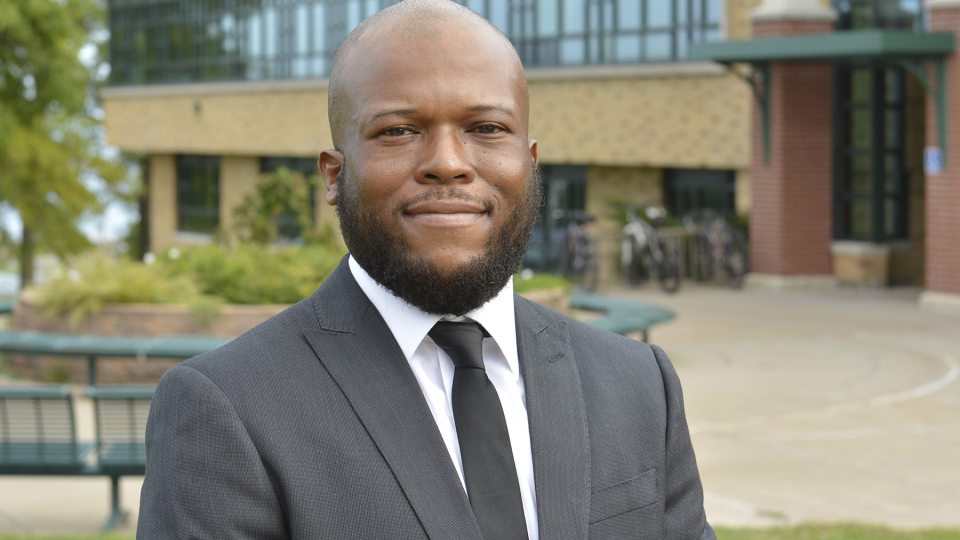 Dr. Isiah Brown stands outside Rich Hall, the college's School of Business