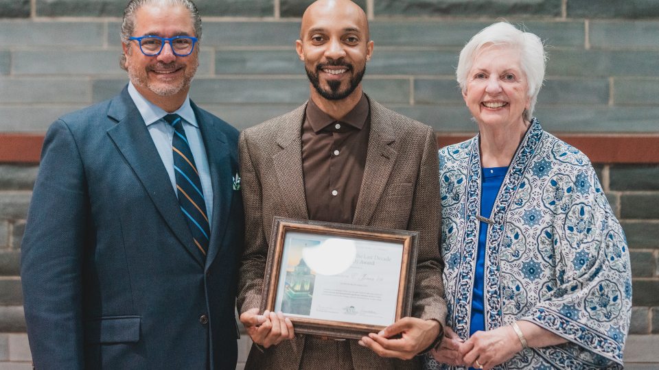 Three-time Emmy Award-winning producer Cameron Jones (center) of SUNY Oswego's Class of 2009 was honored recently by the Oswego Alumni Association with a Graduate Of the Last Decade Alumni Award
