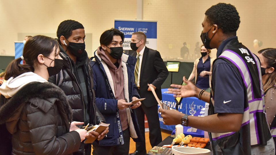 Students speak to a representative at the spring 2022 career and internship fair