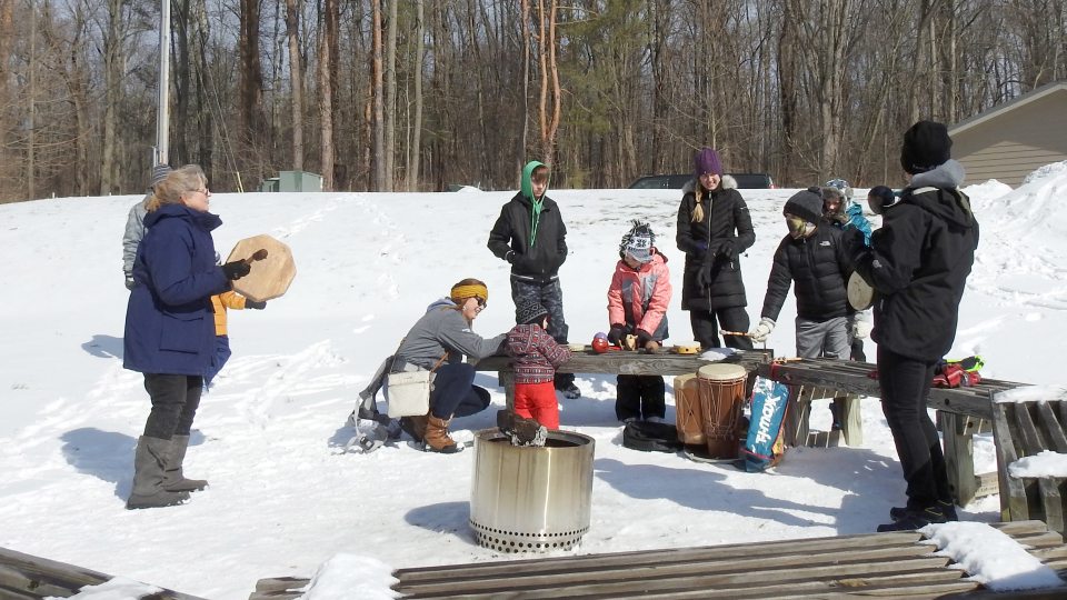 Rice Creek Field Station naturalist Linda Knowles leads a percussion circle by the campfire