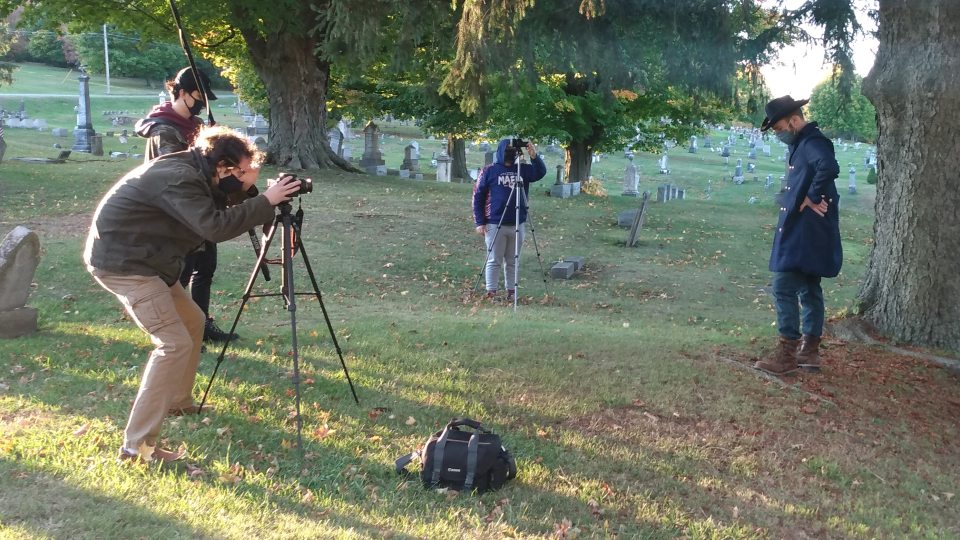 Students acting and filming cemetery storytelling