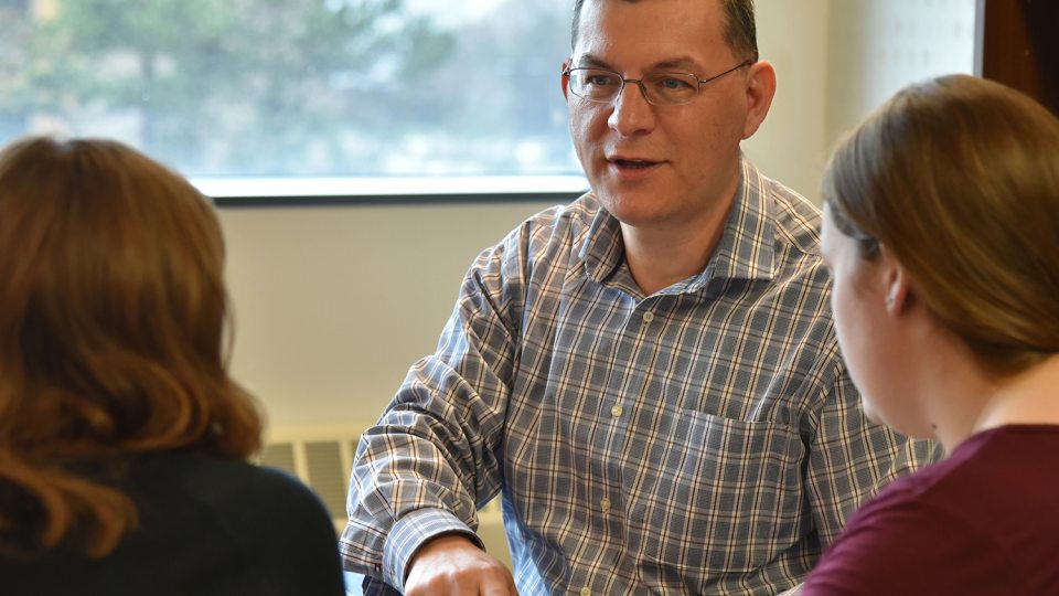 Faculty member Fehmi Damkaci speaks with students