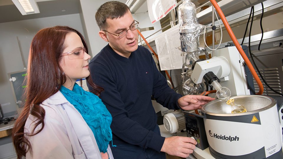 Chemistry professor, Fehmi Damkaci in lab with student