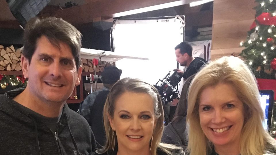 Juliet Giglio, her husband Keith and star Melissa Joan Hart on set of their Hallmark movie Christmas Reservations