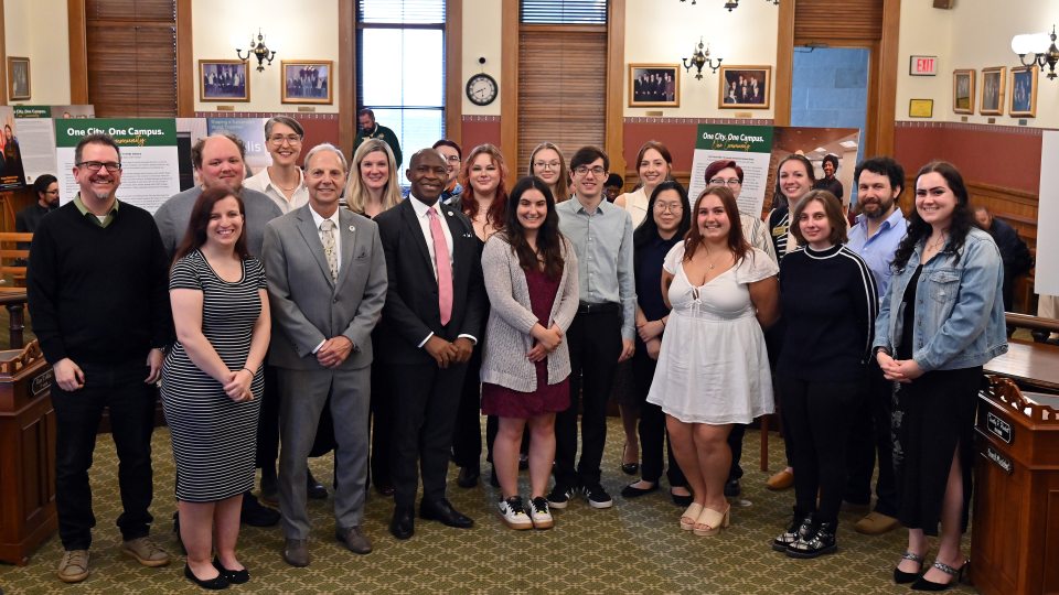 Representations of the City of Oswego and SUNY Oswego gather for an opening reception for the One City. One Campus. One Community. photojournalism project