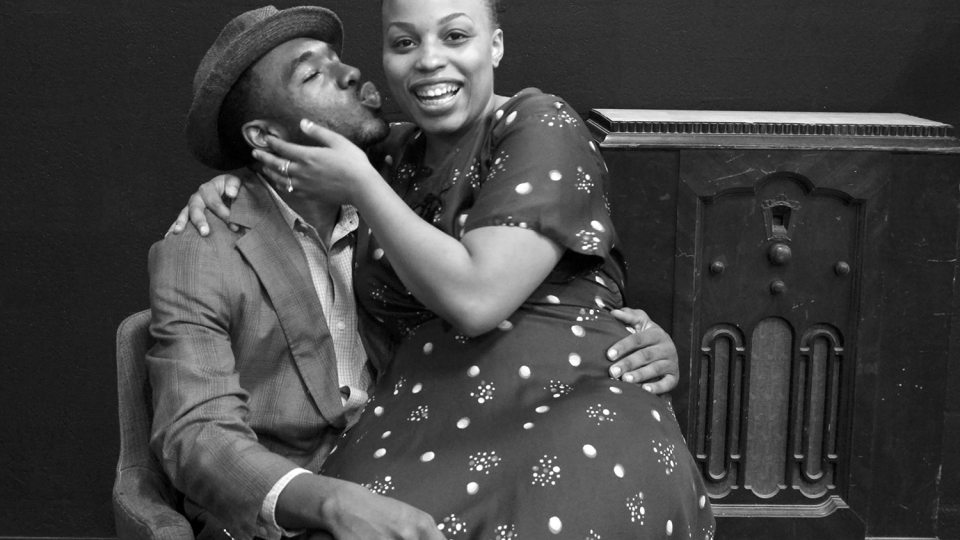 Rehearsal scene of husband and wife celebrating purchasing a new home