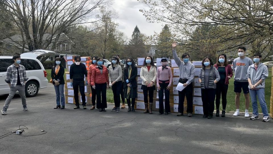 Members of the Chinese-American community with collected PPE which they donated across Central New York