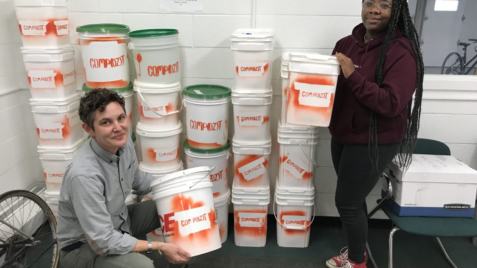 Kate Spector and Dee Canty show off Compozt buckets, which have collected more than a ton of dining hall waste to turn into compost