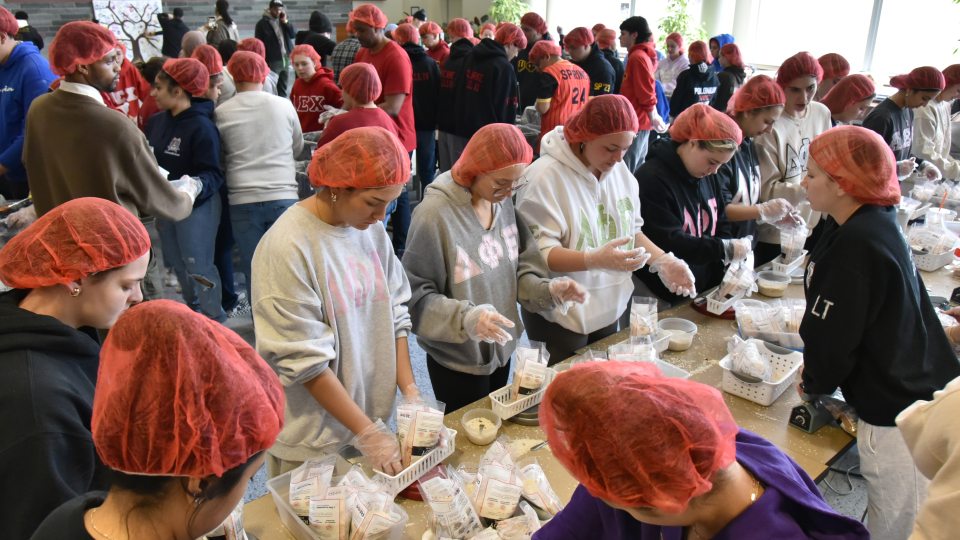SUNY Oswego's MLK Day of Service, shown here with  students preparing food to help local agency Rise Against Hunger