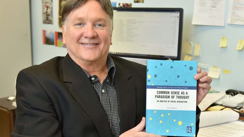 Tim Delaney with book, Common Sense as a Paradigm of Thought